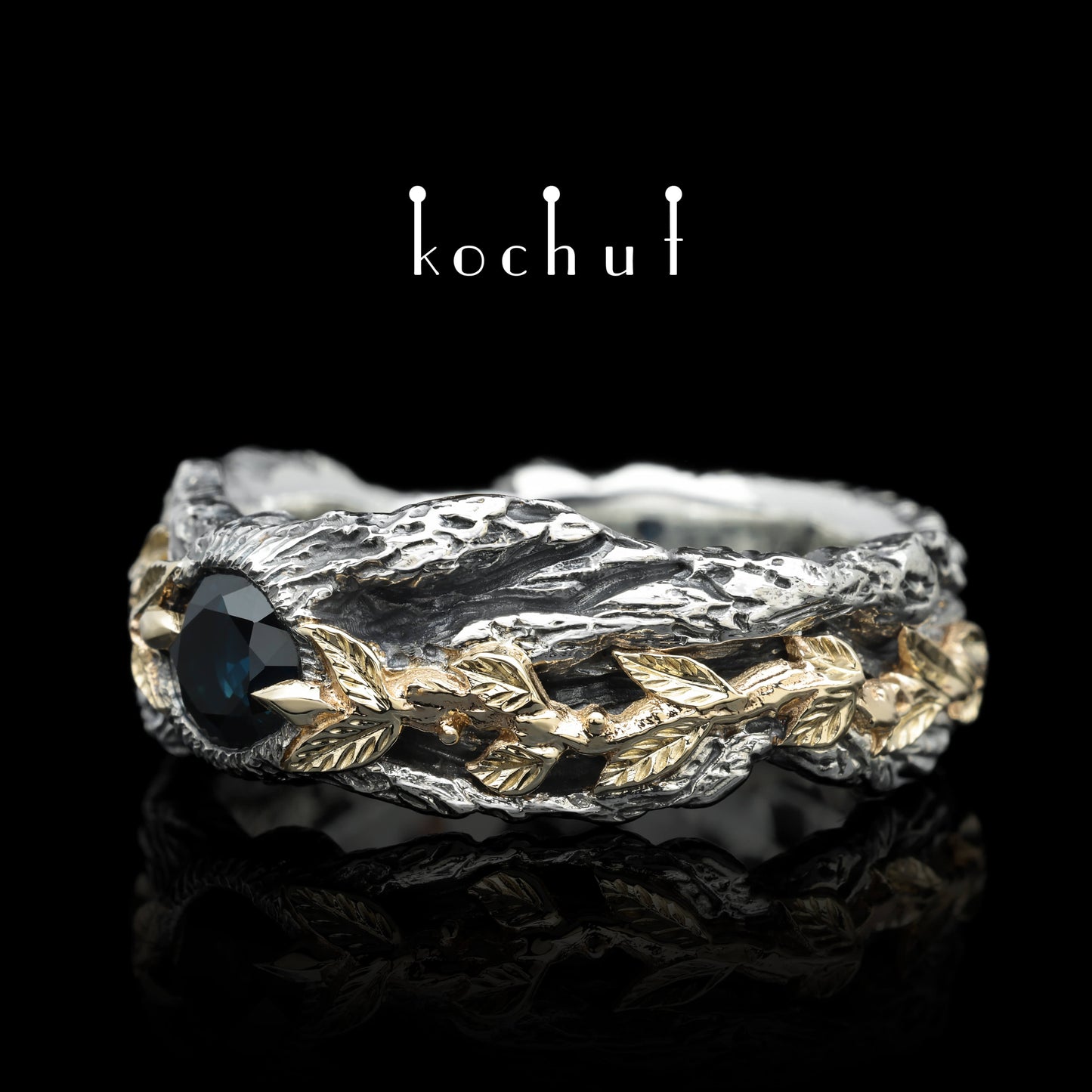 Kraft des Lebens — Ring aus oxidiertem Silber und Gelbgold mit Saphir