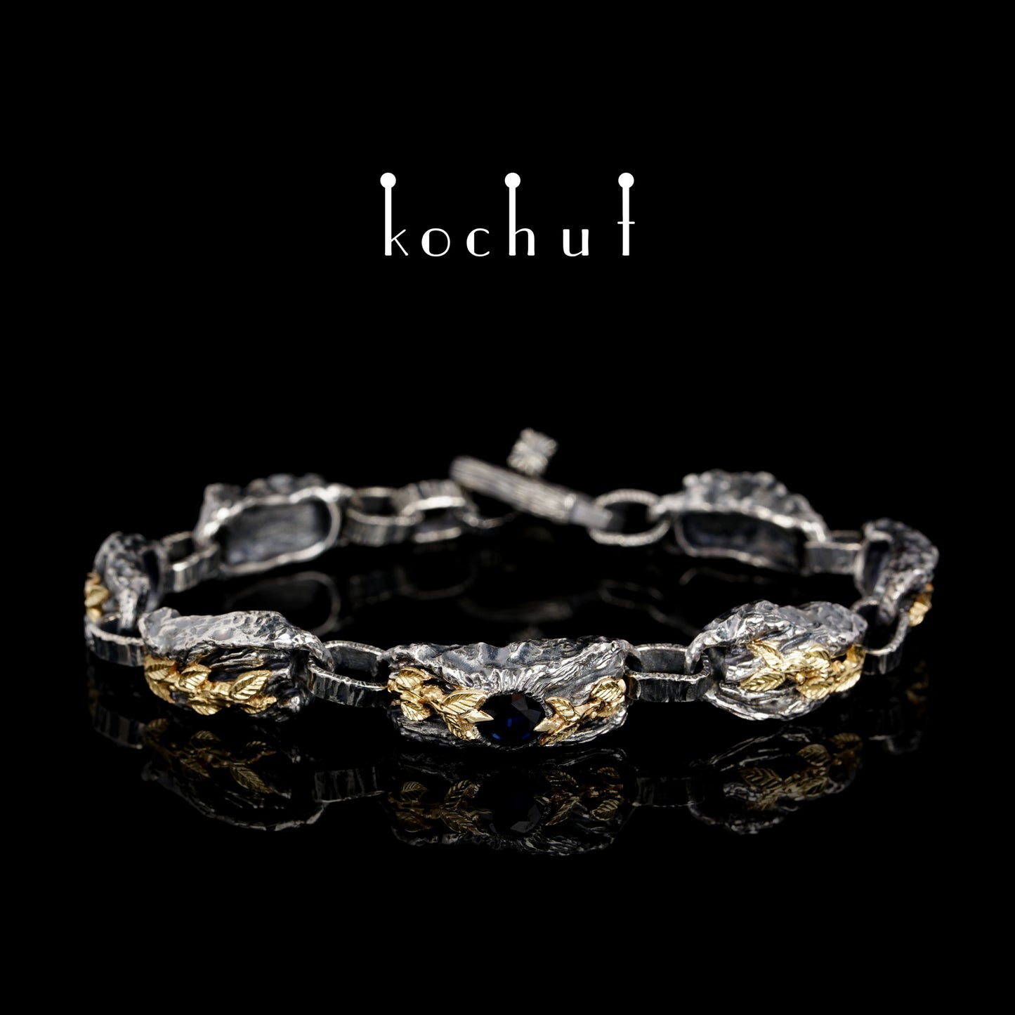 Kraft des Lebens — Armband aus oxidiertem Silber und Gelbgold mit Saphir