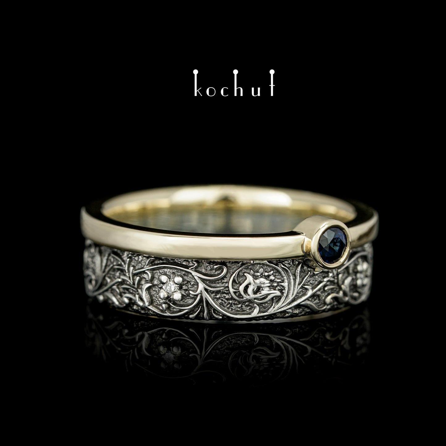 Harmonie der Natur — ein Ring aus Silber und Gelbgold, mit Saphir und Diamanten, beschichtet mit schwarzem Rhodium