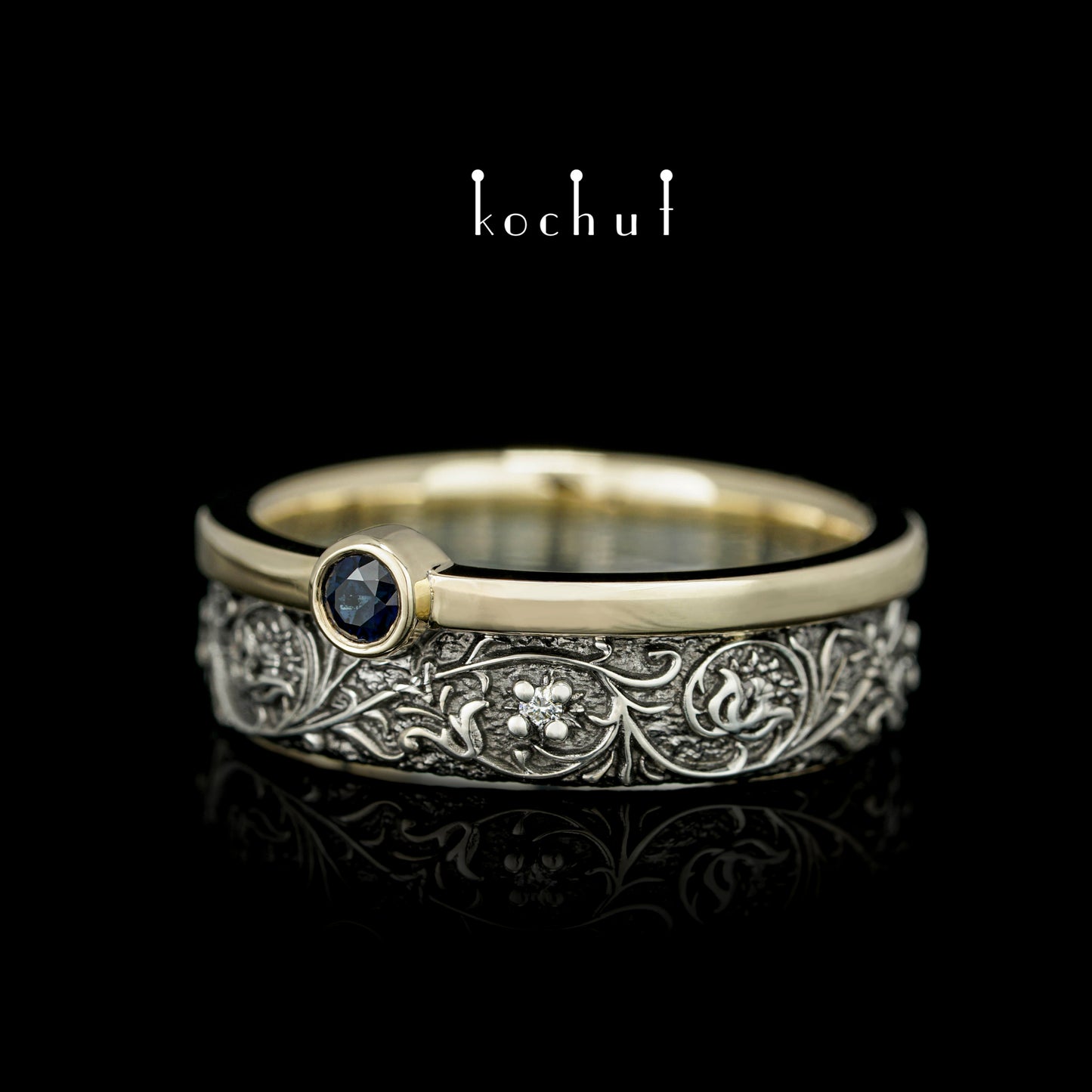 Harmonie der Natur — ein Ring aus Silber und Gelbgold, mit Saphir und Diamanten, beschichtet mit schwarzem Rhodium