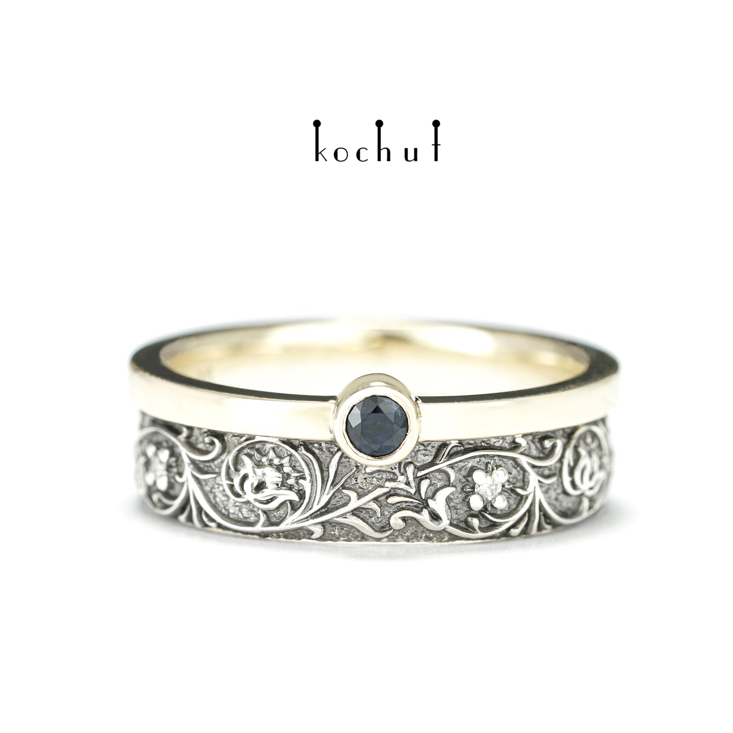 Harmonie der Natur — ein Ring aus Silber und Gelbgold, mit Saphir und Diamanten, beschichtet mit schwarzem Rhodium