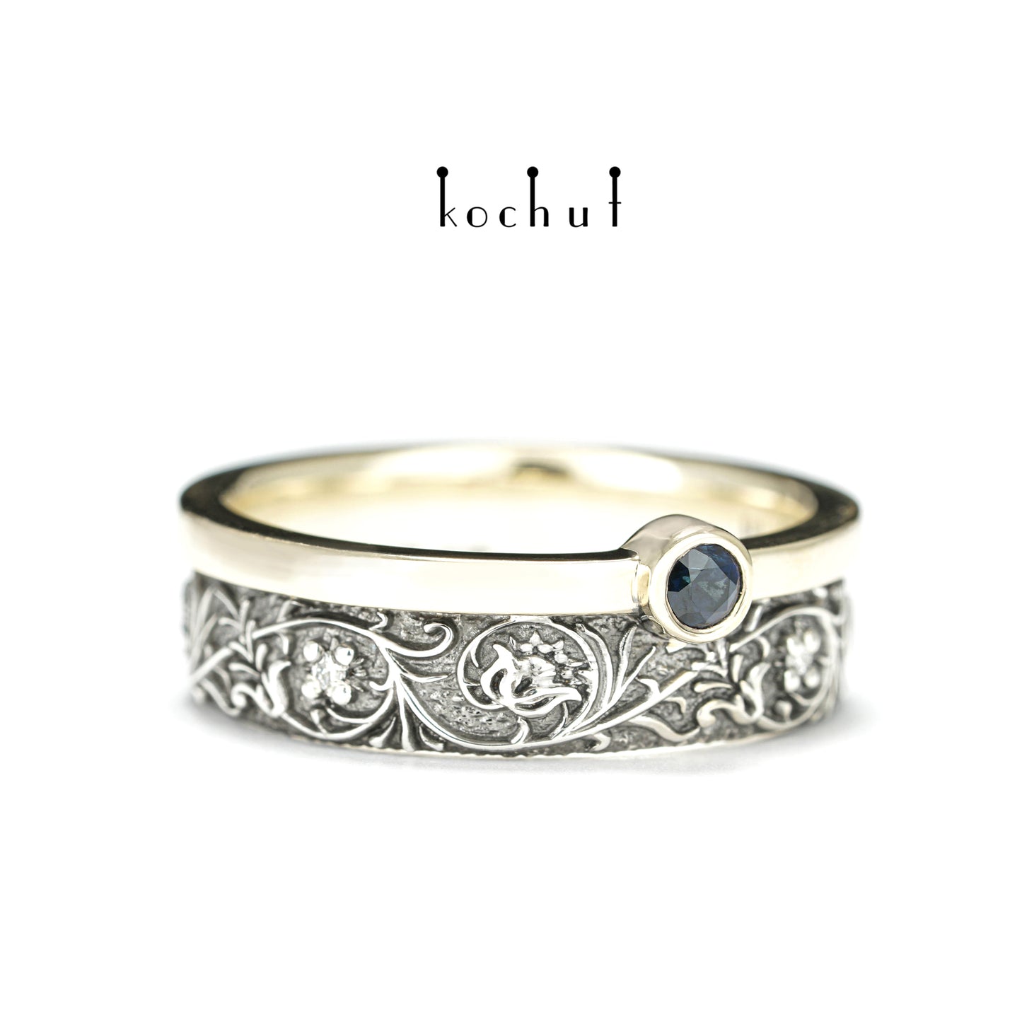 Harmonie der Natur — ein Ring aus Silber und Gelbgold, mit Saphir und Diamanten, beschichtet mit schwarzem Rhodium