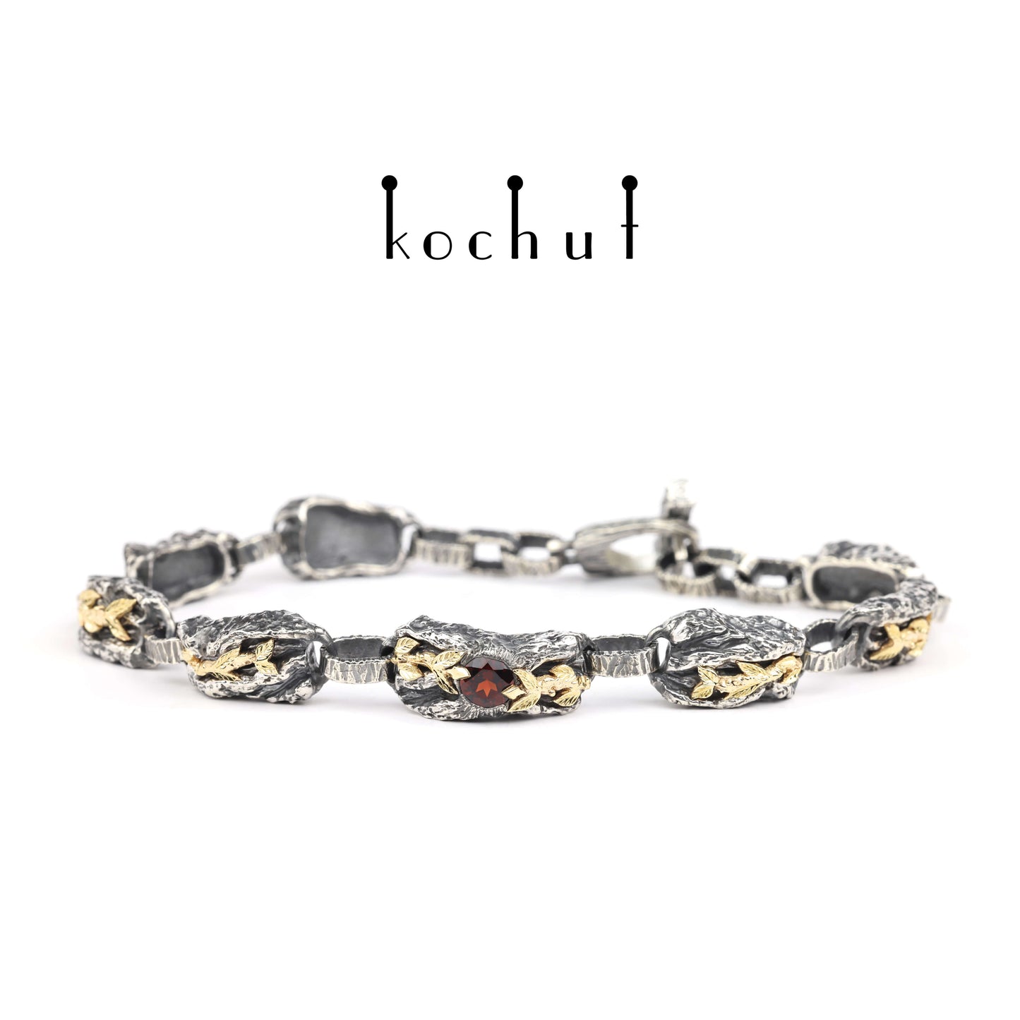 Kraft des Lebens — Armband aus oxidiertem Silber und Gelbgold mit Granat