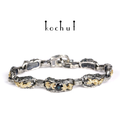 Kraft des Lebens — Armband aus oxidiertem Silber und Gelbgold mit Saphir