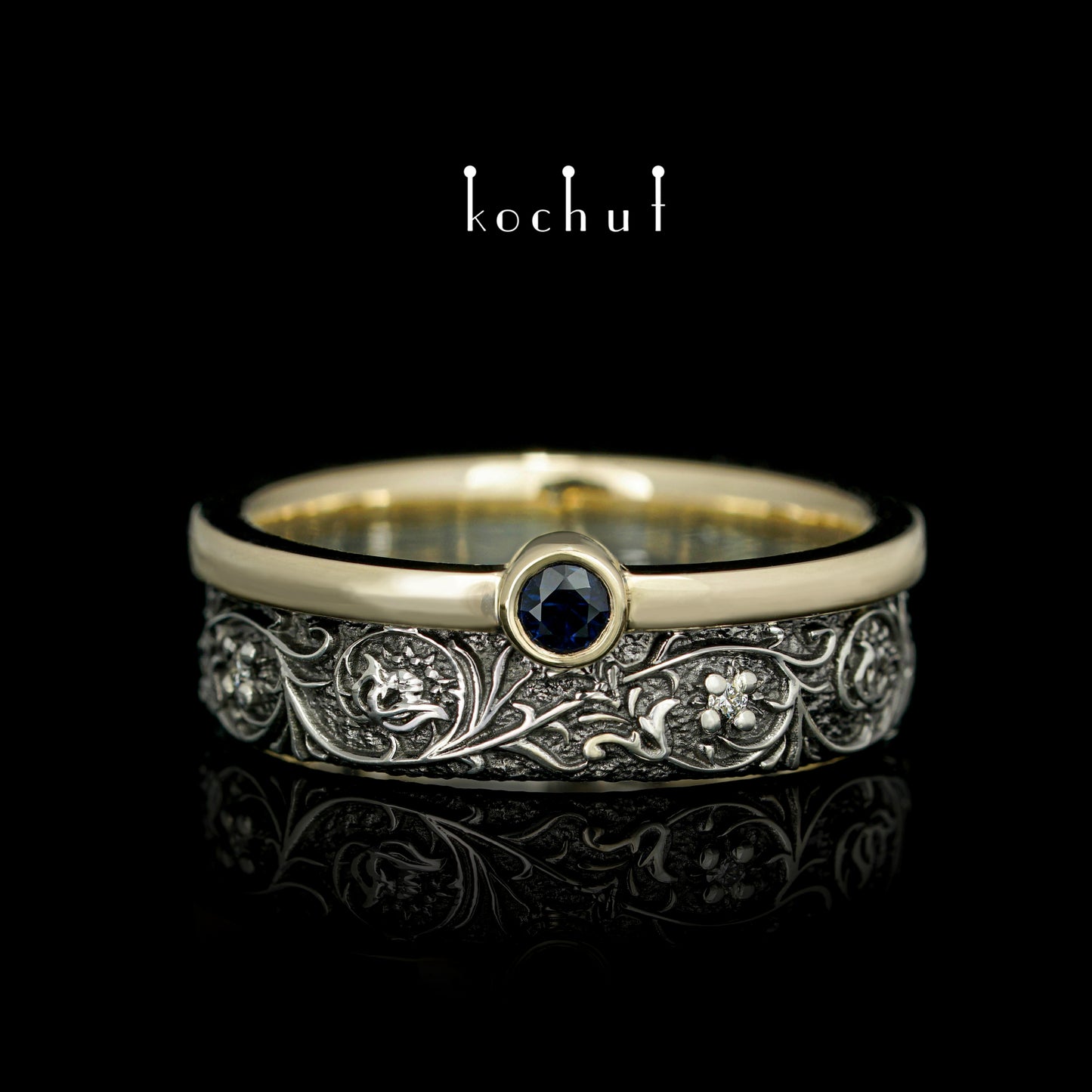 Harmonie der Natur — ein Ring aus Silber und Gelbgold, mit Saphir und Diamanten, beschichtet mit schwarzem Rhodium