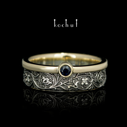 Harmonie der Natur — ein Ring aus Silber und Gelbgold, mit Saphir und Diamanten, beschichtet mit schwarzem Rhodium