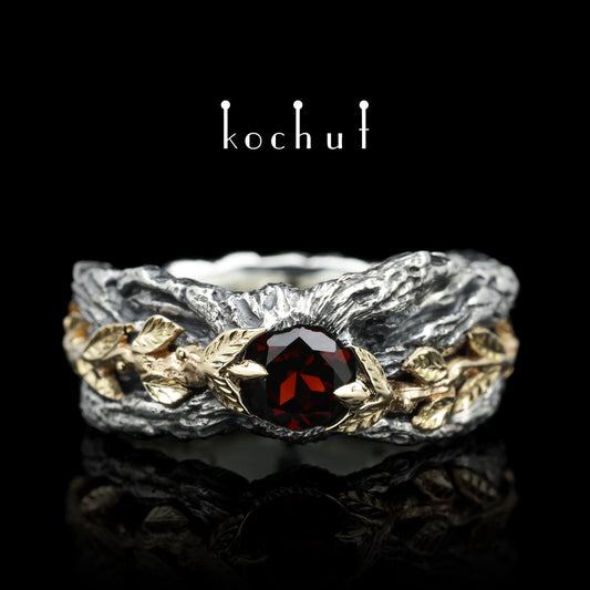 Kraft des Lebens — Ring aus oxidiertem Silber und Gelbgold mit Granat