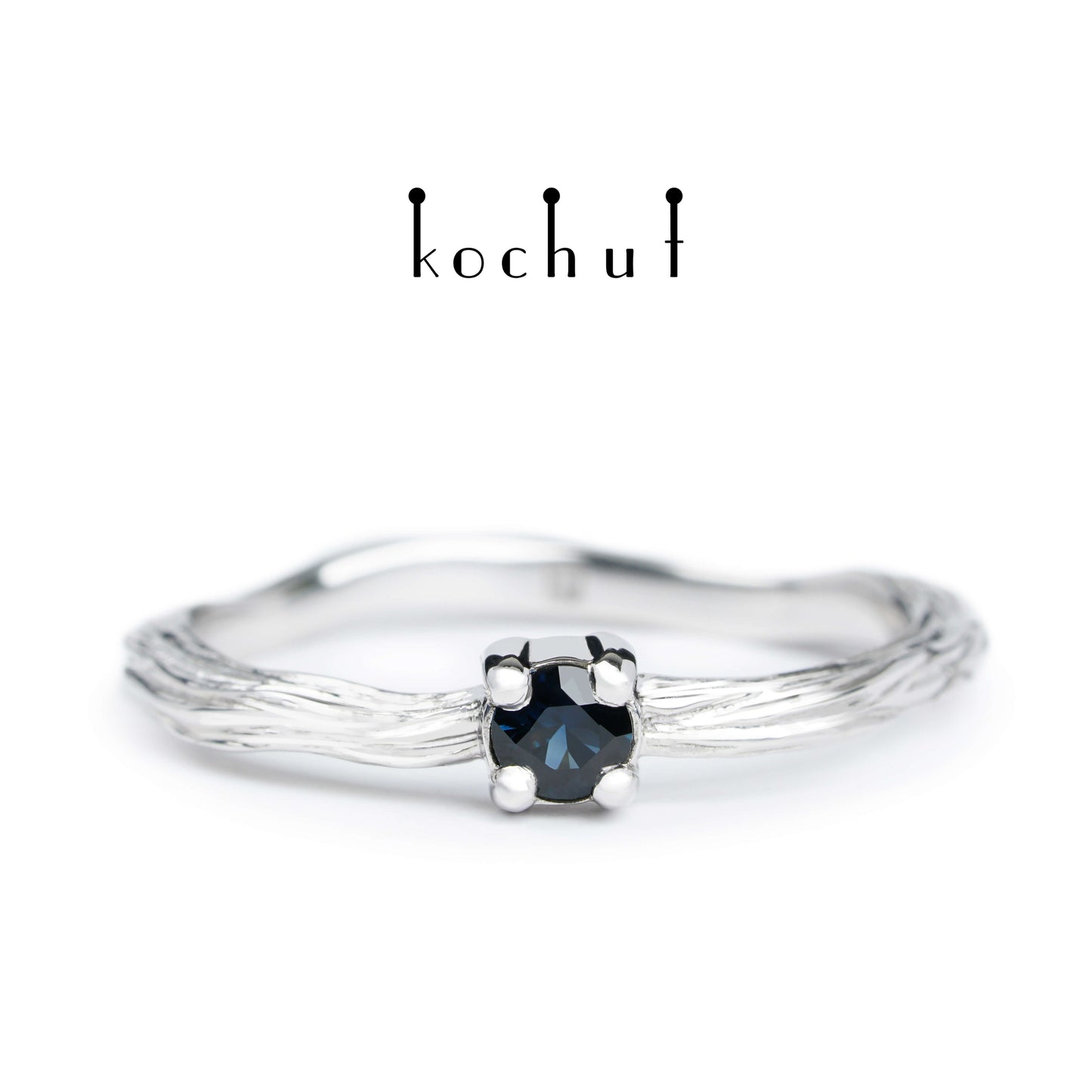 Winterzweig — silberner Ring mit weißer Rhodium-Beschichtung und Saphir
