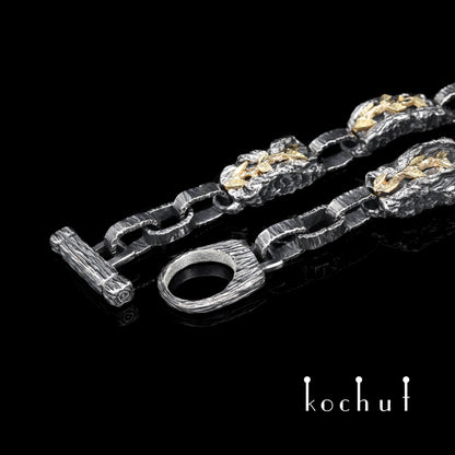 Kraft des Lebens — Armband aus oxidiertem Silber und Gelbgold mit Granat