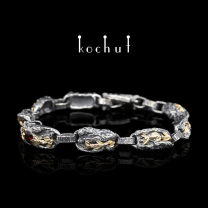 Kraft des Lebens — Armband aus oxidiertem Silber und Gelbgold mit Granat
