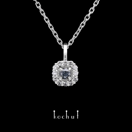 Zeitlos — Anhänger aus Weißgold mit einem blauen Diamanten und einer Streuung weißer Diamanten, beschichtet mit weißem Rhodium